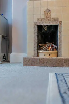 a fireplace with a pile of garbage in a room at 107a - 3 Double Bedrooms in Lytham St Annes
