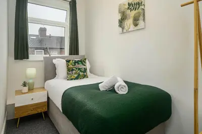 a small bedroom with a bed and a window at Willow House - 2-Bedroom House In Merseyside! in Birkenhead