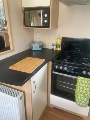 a kitchen with a stove and a counter top at 147a Port Haverigg in Millom