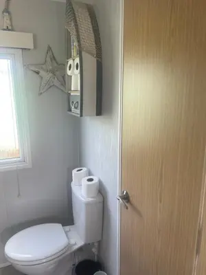 a bathroom with a toilet and a door at 147a Port Haverigg in Millom