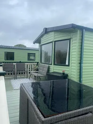 a green house with a swimming pool on a deck at 147a Port Haverigg in Millom