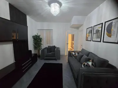 a living room with a couch and a television at Lily in Blackpool