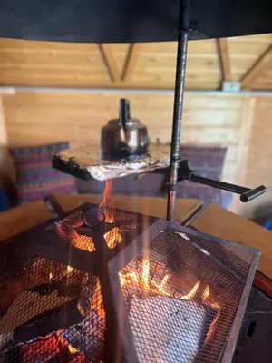 a stove top with a pot on top of it at Off GRID Hobbit Hut with Wood Burning Hot tub NO SHOWER in Hapton