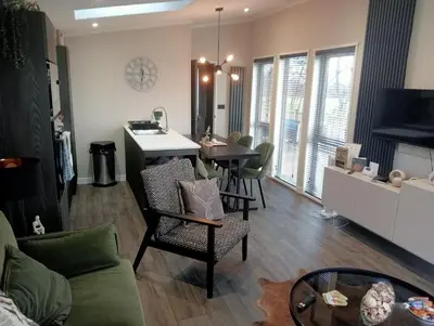 a living room with a kitchen and a dining room at Lake View Lodge in Lytham St Annes