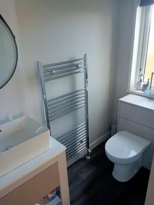 a bathroom with a white toilet and a sink at Lake View Lodge in Lytham St Annes