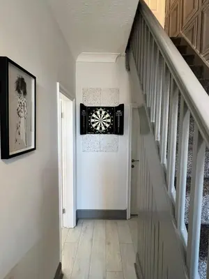 a hallway with a white staircase with a white door at Beachside Suites - HOT TUB sleeps 10 in Blackpool