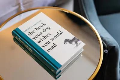 two books sitting on a table in a mirror at Aynsome Manor in Cartmel