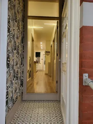 a hallway with a door leading into a room at Country Style Modern Self Catering 3 Bedroom Bungalow in Blackpool in Blackpool