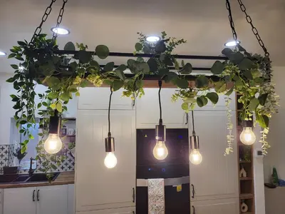 a group of lights hanging from a ceiling with plants at Country Style Modern Self Catering 3 Bedroom Bungalow in Blackpool in Blackpool