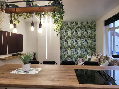 a dining room with a table and a tv at Country Style Modern Self Catering 3 Bedroom Bungalow in Blackpool in Blackpool