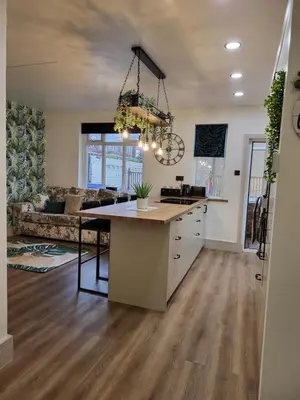 a kitchen with a island in the middle of a room at Country Style Modern Self Catering 3 Bedroom Bungalow in Blackpool in Blackpool