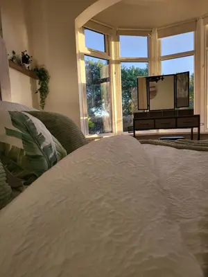 a bedroom with a bed and a large window at Country Style Modern Self Catering 3 Bedroom Bungalow in Blackpool in Blackpool