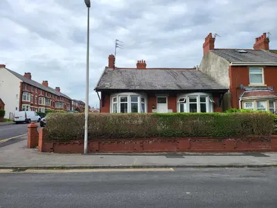 a red brick house on the side of a street at Country Style Modern Self Catering 3 Bedroom Bungalow in Blackpool in Blackpool