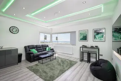 a living room with a couch and a table at Haven Heights International in Blackpool