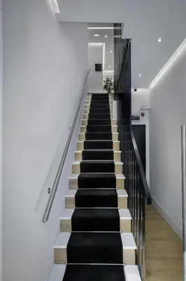 a staircase in a house with black and white stairs at Haven Heights International in Blackpool
