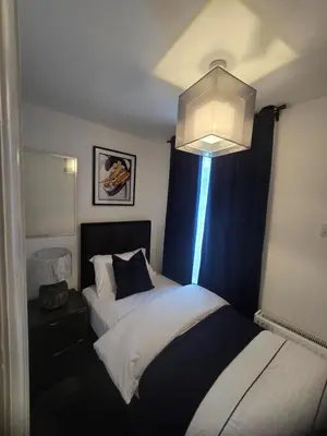 a hotel room with two beds and a chandelier at Seaside Retreat on Fleet Street in Blackpool