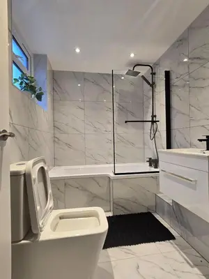 a bathroom with a shower and a toilet and a sink at Seaside Retreat on Fleet Street in Blackpool