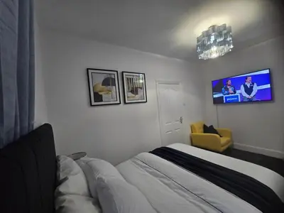 a bedroom with a bed and a tv on the wall at Seaside Retreat on Fleet Street in Blackpool