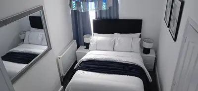 a small room with a bed and a mirror at Seaside Retreat on Fleet Street in Blackpool