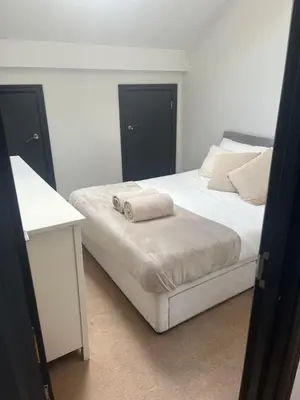 a bedroom with a bed with two towels on it at 2 Bedroom City Centre Penthouse Loft Apartment in Liverpool