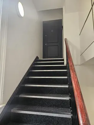 a staircase with a black door in a building at 2 Bedroom City Centre Penthouse Loft Apartment in Liverpool