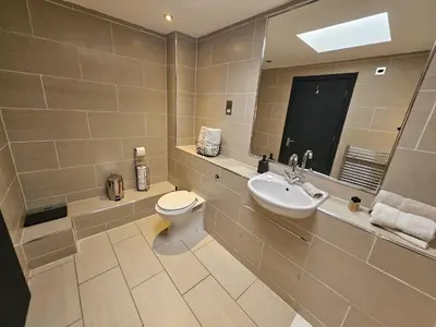 a bathroom with a toilet and a sink at 2 Bedroom City Centre Penthouse Loft Apartment in Liverpool