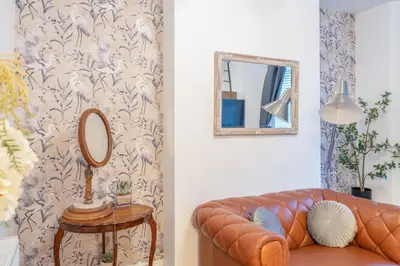 a living room with a couch and a mirror at Fabulous New 1 Bedroom Ground Floor Flat in Morecambe