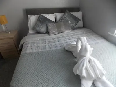 a bedroom with a bed with towels on it at The Celtic Pride Hotel in Blackpool