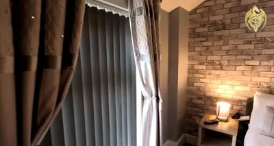 a window with curtains and a candle on a table at The Celtic Pride Hotel in Blackpool