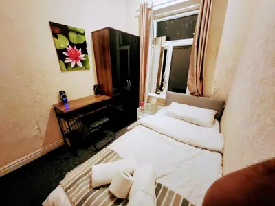 a small room with a bed and a window at Boxroom SB Hatfield RD in Bolton