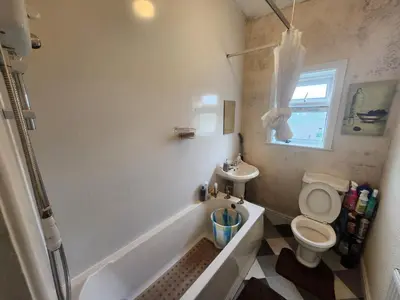 a bathroom with a tub and a toilet and a sink at Boxroom SB Hatfield RD in Bolton
