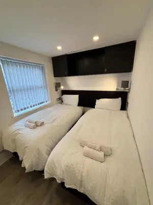 two beds sitting next to each other in a bedroom at Williamson Suites - Apartment 1 in Liverpool