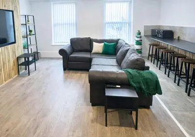 a living room with a couch and a table at Williamson Suites - Apartment 1 in Liverpool