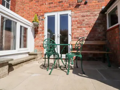 two chairs and a table in front of a building at Mullans in Southport