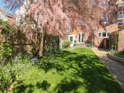a garden in a house with a tree at Mullans in Southport