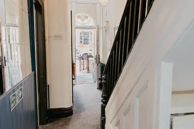 a hallway of a building with a door in the distance at Glen Allan Hotel in Blackpool