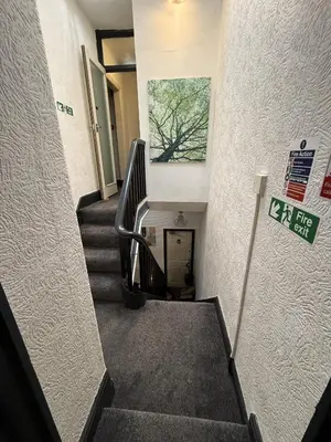 a staircase in a building with a sign on the wall at Glen Allan Hotel in Blackpool