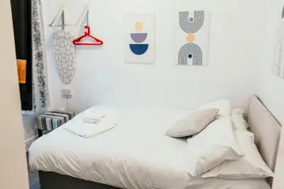 a white bed with white sheets and pillows in a bedroom at Glen Allan Hotel in Blackpool