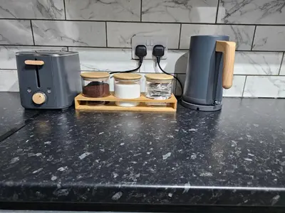 a counter top with a coffee maker and a coffee pot at Convenient 3 bed, Pr1 near Uclan n Train station in Preston