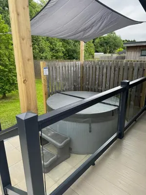 an umbrella sitting on top of a deck at luxury hot tub glamping apartment in Ireleth