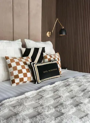 a bedroom with a bed with pillows and a lamp at Secret Suites in Lancaster