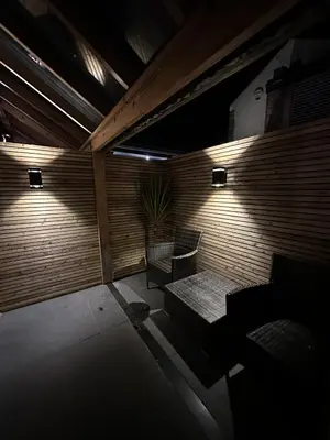 a room with a bench and a table and a chair at Secret Suites in Lancaster