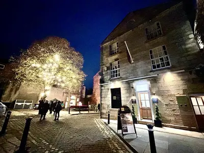 a group of people walking down a street at night at Secret Suites in Lancaster