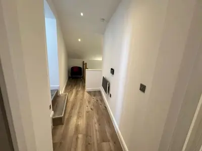 a hallway with white walls and a wooden floor at Dale Street Apartments Liverpool by Beehosting in Liverpool