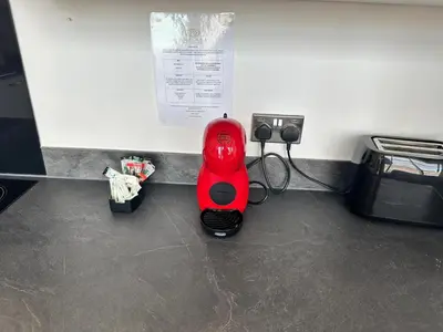 a red object sitting on the floor in a room at Dale Street Apartments Liverpool by Beehosting in Liverpool