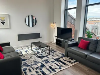 a living room with a couch and a tv at Dale Street Apartments Liverpool by Beehosting in Liverpool