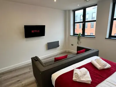a bedroom with a bed and a tv on the wall at Dale Street Apartments Liverpool by Beehosting in Liverpool