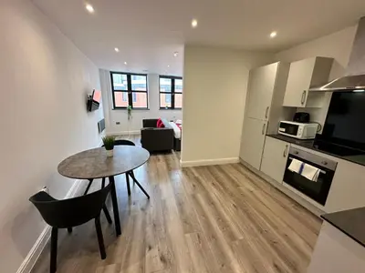 a kitchen and living room with a table and a dining room at Dale Street Apartments Liverpool by Beehosting in Liverpool