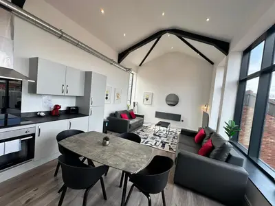a kitchen and living room with a table and chairs at Dale Street Apartments Liverpool by Beehosting in Liverpool