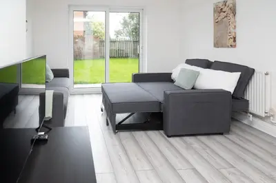 a living room with a couch and a tv at Quiet 3 bed house, pet friendly in Kirkby